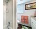 Bright bathroom featuring tile shower and framed window at 1120 81St S St, St Petersburg, FL 33707