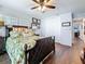 Comfortable bedroom featuring wood floors, fan, and en suite bath at 1120 81St S St, St Petersburg, FL 33707