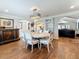 Spacious dining room with a modern chandelier and dark wood floors at 1120 81St S St, St Petersburg, FL 33707