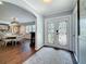 Bright foyer with decorative glass double doors, a patterned rug and view into dining room at 1120 81St S St, St Petersburg, FL 33707