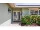 Home's facade features decorative doors and manicured landscaping in a tranquil setting at 1120 81St S St, St Petersburg, FL 33707