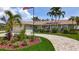 Attractive home with brick driveway, mature palms, green lawn, and lovely landscaping elements at 1120 81St S St, St Petersburg, FL 33707
