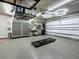 Well-lit garage with epoxy floors, garage storage cabinets, and ample workspace at 1120 81St S St, St Petersburg, FL 33707