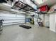 Spacious garage with epoxy floors, overhead storage racks, and well-organized tools and equipment at 1120 81St S St, St Petersburg, FL 33707