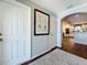 Interior hallway with hardwood flooring and a view of the home's kitchen at 1120 81St S St, St Petersburg, FL 33707