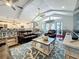 Open-concept living room with vaulted ceiling, view of the kitchen, and access to the outdoors at 1120 81St S St, St Petersburg, FL 33707