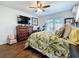 Bright main bedroom with wood floors, closet, ceiling fan, and French door access at 1120 81St S St, St Petersburg, FL 33707