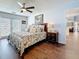 Comfortable main bedroom featuring a ceiling fan, wood floors, and adjacent bathroom access at 1120 81St S St, St Petersburg, FL 33707