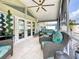 Screened patio featuring wicker furniture and tile flooring at 1120 81St S St, St Petersburg, FL 33707