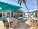 Backyard patio with dining, lounge seating, screened-in lanai, and sparkling pool area at 1120 81St S St, St Petersburg, FL 33707