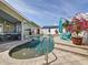 Relaxing backyard pool with lush landscaping and a calming spa waterfall feature at 1120 81St S St, St Petersburg, FL 33707