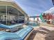 Inviting backyard pool with lounge chairs, screened-in lanai, and a private outdoor space at 1120 81St S St, St Petersburg, FL 33707