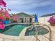 Backyard pool and patio featuring a jacuzzi with access rails, tropical plants and exterior home view at 1120 81St S St, St Petersburg, FL 33707