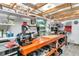 A functional workshop featuring ample shelving, a large worktable, and great lighting at 161 27Th N Ave, St Petersburg, FL 33704
