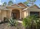 Inviting single-story home with a welcoming entryway and an attached multi-car garage at 7190 Raymond Pl, Spring Hill, FL 34607