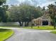 Landscaped single-story home featuring a symmetrical front facade and a lush green lawn at 7190 Raymond Pl, Spring Hill, FL 34607