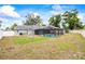 A large backyard features a screened-in pool and storage shed at 2204 Krista Ln, Brandon, FL 33511