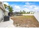 Spacious backyard with screened-in pool area, AC unit, and fencing at 2204 Krista Ln, Brandon, FL 33511