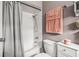 Bathroom features shower over tub with gray tile and shower curtain at 2204 Krista Ln, Brandon, FL 33511
