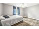 Bright bedroom with a ceiling fan, grey walls, and hardwood floors, creating a serene atmosphere at 2204 Krista Ln, Brandon, FL 33511