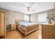 Bedroom features light wood furniture, wood floors, and a ceiling fan at 2204 Krista Ln, Brandon, FL 33511