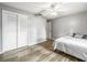 Bright bedroom features wood-look floors, ceiling fan, and double door closet at 2204 Krista Ln, Brandon, FL 33511