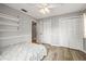 Bedroom features built-in shelving, ceiling fan, and closet space at 2204 Krista Ln, Brandon, FL 33511