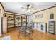 Well-lit dining room showcasing built-in shelving, modern cabinetry, and a glass table set at 2204 Krista Ln, Brandon, FL 33511