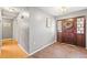 Welcoming foyer featuring a beautiful wooden door and classic brick flooring at 2204 Krista Ln, Brandon, FL 33511