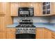 Kitchen showcasing stainless steel stove and microwave paired with light wood cabinets and light countertops at 2204 Krista Ln, Brandon, FL 33511