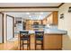 Kitchen featuring light wood cabinets, a breakfast bar, stainless steel appliances, and hardwood floors at 2204 Krista Ln, Brandon, FL 33511