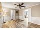 Bright living room featuring wood floors, neutral paint, modern lighting, and doorway views to other rooms at 2204 Krista Ln, Brandon, FL 33511