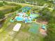 Aerial view of the community featuring tennis courts, pool, clubhouse, sand volleyball, and play area at 18941 Twinberry Dr, Tampa, FL 33647