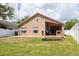 Wide backyard with a manicured lawn, privacy fence, and a glimpse of the home's exterior at 18941 Twinberry Dr, Tampa, FL 33647