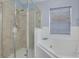 Bathroom features a shower, tub and a window for natural lighting at 18941 Twinberry Dr, Tampa, FL 33647