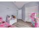 Bedroom with light blue walls, wood-look floors, closet, and a dollhouse at 18941 Twinberry Dr, Tampa, FL 33647