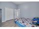 Bedroom with light blue walls, wood-look floors, and a double door closet at 18941 Twinberry Dr, Tampa, FL 33647