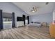 Spacious bedroom with vaulted ceilings, ceiling fan, and large windows with views of the property at 18941 Twinberry Dr, Tampa, FL 33647