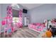 Bedroom with light blue walls, wood-look floors, and a TV mounted on the wall at 18941 Twinberry Dr, Tampa, FL 33647