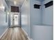 Bright foyer with wood-look flooring, fresh paint, and a bench at 18941 Twinberry Dr, Tampa, FL 33647