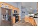 View of a spacious kitchen with stainless steel appliances and light wood cabinets at 18941 Twinberry Dr, Tampa, FL 33647