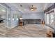 Open living room featuring wood flooring, a ceiling fan, and a large comfortable gray couch at 18941 Twinberry Dr, Tampa, FL 33647