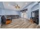 Spacious living room with wood floors, fresh paint, ceiling fan and double doors to the backyard at 18941 Twinberry Dr, Tampa, FL 33647