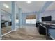 Home office with wood floors, neutral paint, large window and custom mirrors at 18941 Twinberry Dr, Tampa, FL 33647