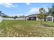 Expansive backyard with lush green grass, white fence, and outdoor patio at 13365 Chesapeake Pl, Spring Hill, FL 34609