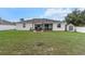 A backyard showcasing a covered patio with seating area and a storage shed at 13365 Chesapeake Pl, Spring Hill, FL 34609