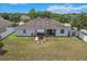 Aerial view of the backyard, featuring a patio, firepit, and fenced perimeter at 13365 Chesapeake Pl, Spring Hill, FL 34609
