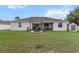 Backyard featuring a covered patio area complete with seating and a storage shed at 13365 Chesapeake Pl, Spring Hill, FL 34609