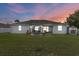 Spacious backyard featuring a patio, outdoor seating, lush green lawn, and storage shed at 13365 Chesapeake Pl, Spring Hill, FL 34609