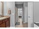 Bathroom vanity featuring stone countertop and doorway leading to bedroom at 13365 Chesapeake Pl, Spring Hill, FL 34609